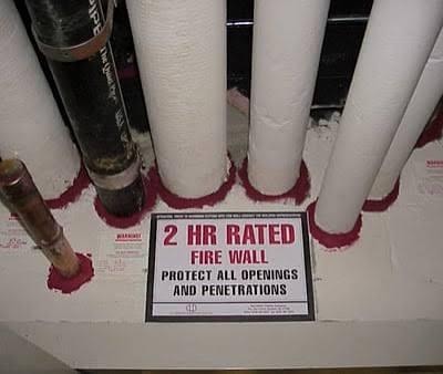 Pipe penetrations through fire-rated wall